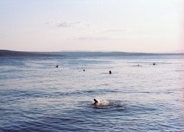 lanscape photography on film , sea with swimmers 