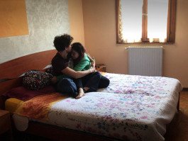 couple hugging on bed in bedroom, reportage photography, webcam 