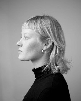 studio portrait of young woman profile in black and white moody expression 
